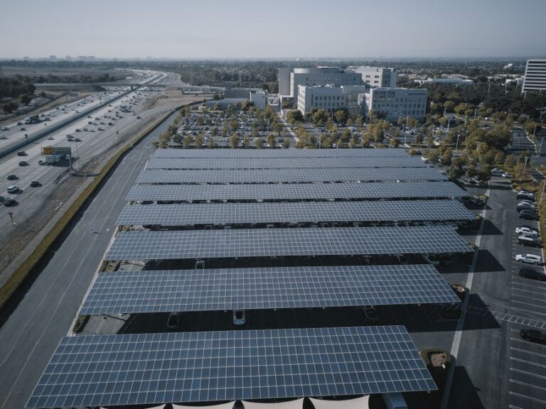 solar panels on residential rooftop charging electric vehicle with clear blue sky