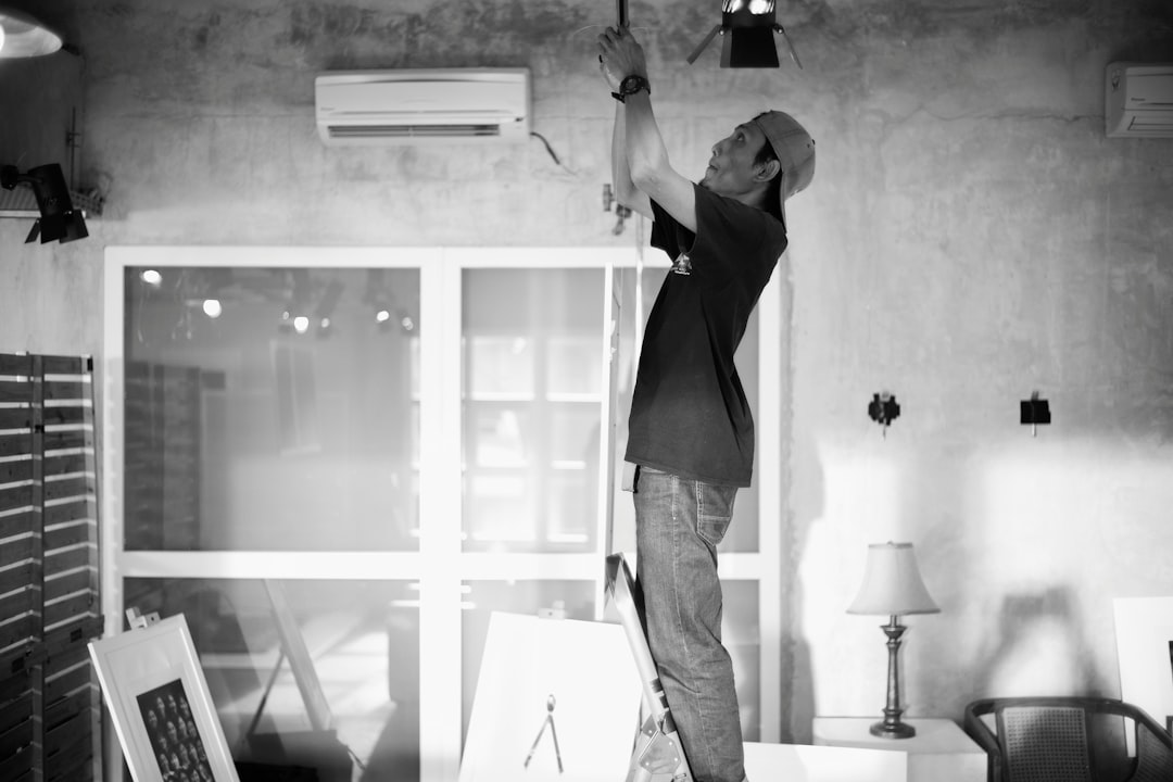 air conditioner tune-up technician performing AC maintenance check - best time of year to tune up your air conditioner