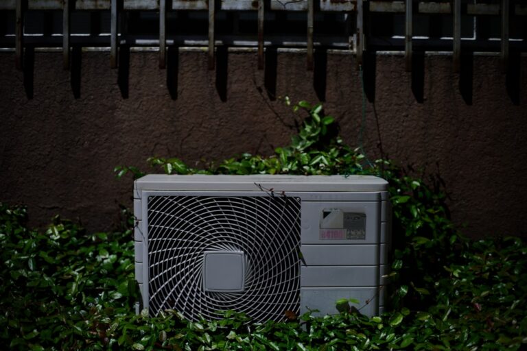 aging outdoor AC unit in a suburban San Diego backyard - signs your ac is nearing end of life