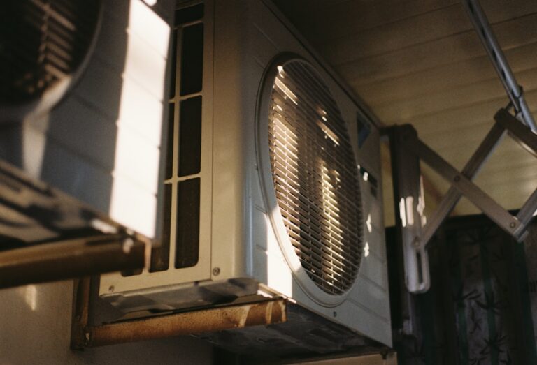 air conditioning unit under bright summer sun - why some air conditioners fail earlier in hot regions