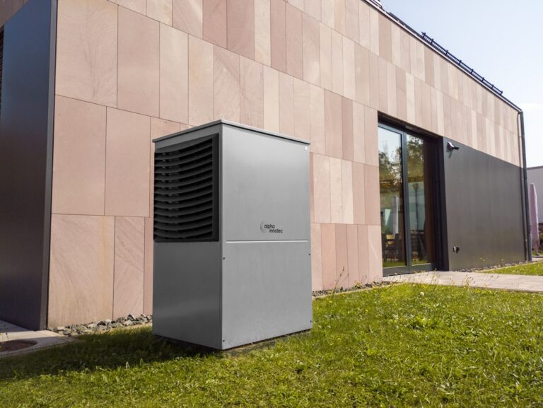 modern central air conditioning unit outside a suburban home - ac lifespan