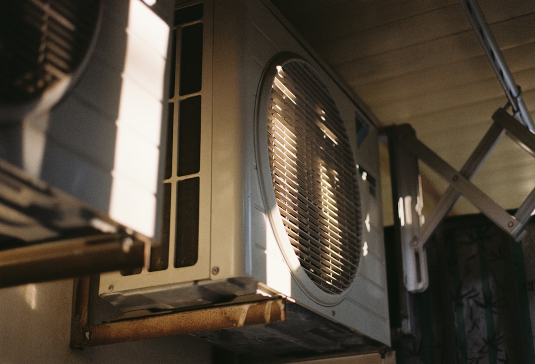 air conditioning unit under bright summer sun - why some air conditioners fail earlier in hot regions